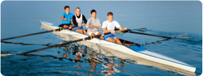 Crew team rowing on a river