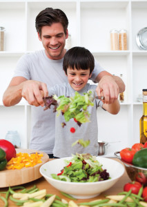 little boy and father cooking to eat well