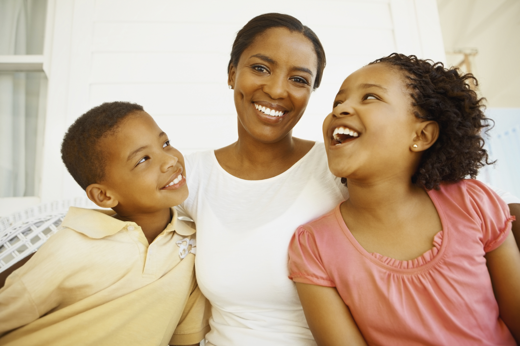 Portrait of an African American mother sitting with happy son and daughter