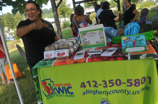 WIC representative talking to community members about gardening at home.
