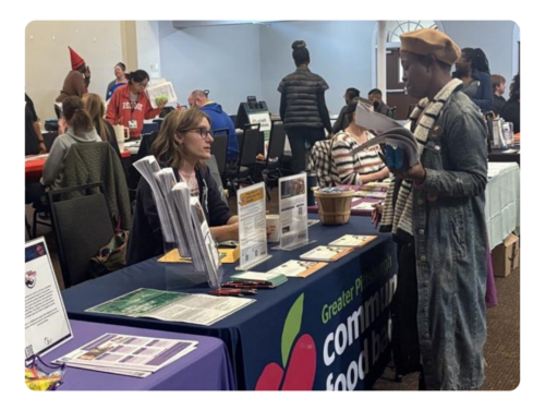 Live Well Partners network with community members at tabling event.